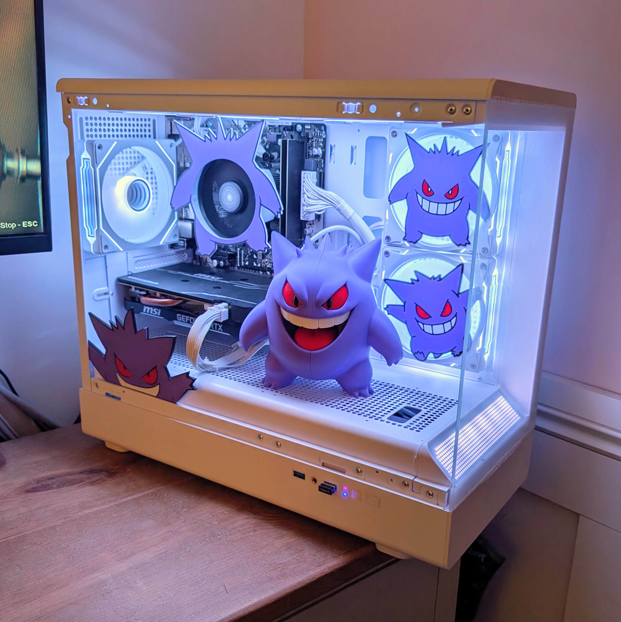 White gaming PC with a Gengar custom case theme and purple lighting